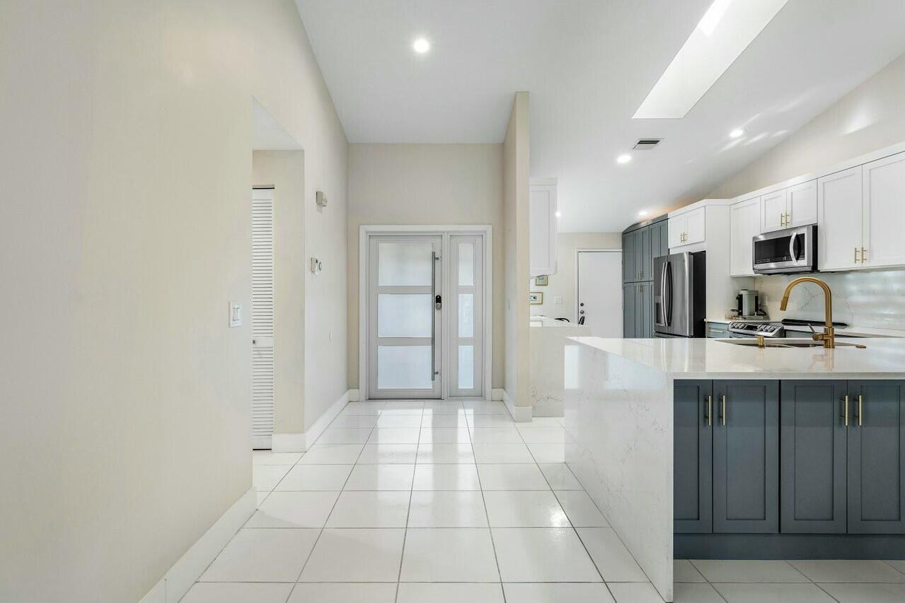 8211 Springlake Drive Boca Raton, FL 33496 - Photo 6 of 49 a bathroom with a sink a mirror and a shower