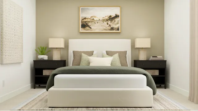 a bedroom with a bed and a painting on the wall