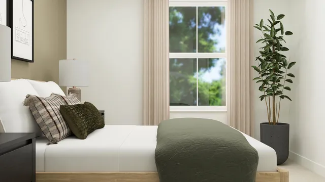 a bedroom with a bed window and potted plant