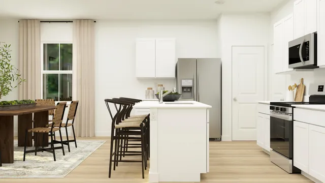 a kitchen with stainless steel appliances a stove a sink refrigerator and a dining table with wooden floor