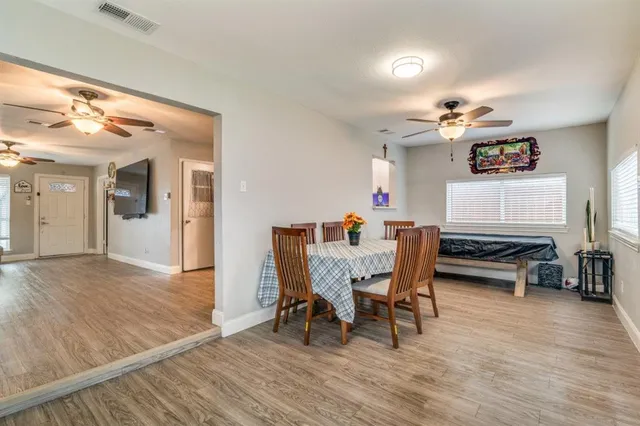 a dining room with furniture and wooden floor