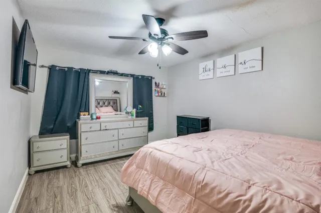 a bedroom with a bed and a dresser