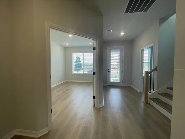 an empty room with wooden floor and a window