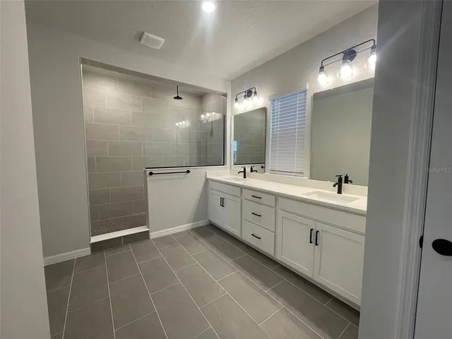 a bathroom with a double vanity sink mirror and double