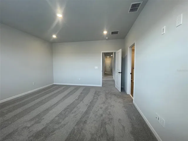 an empty room with wooden floor and sliding door