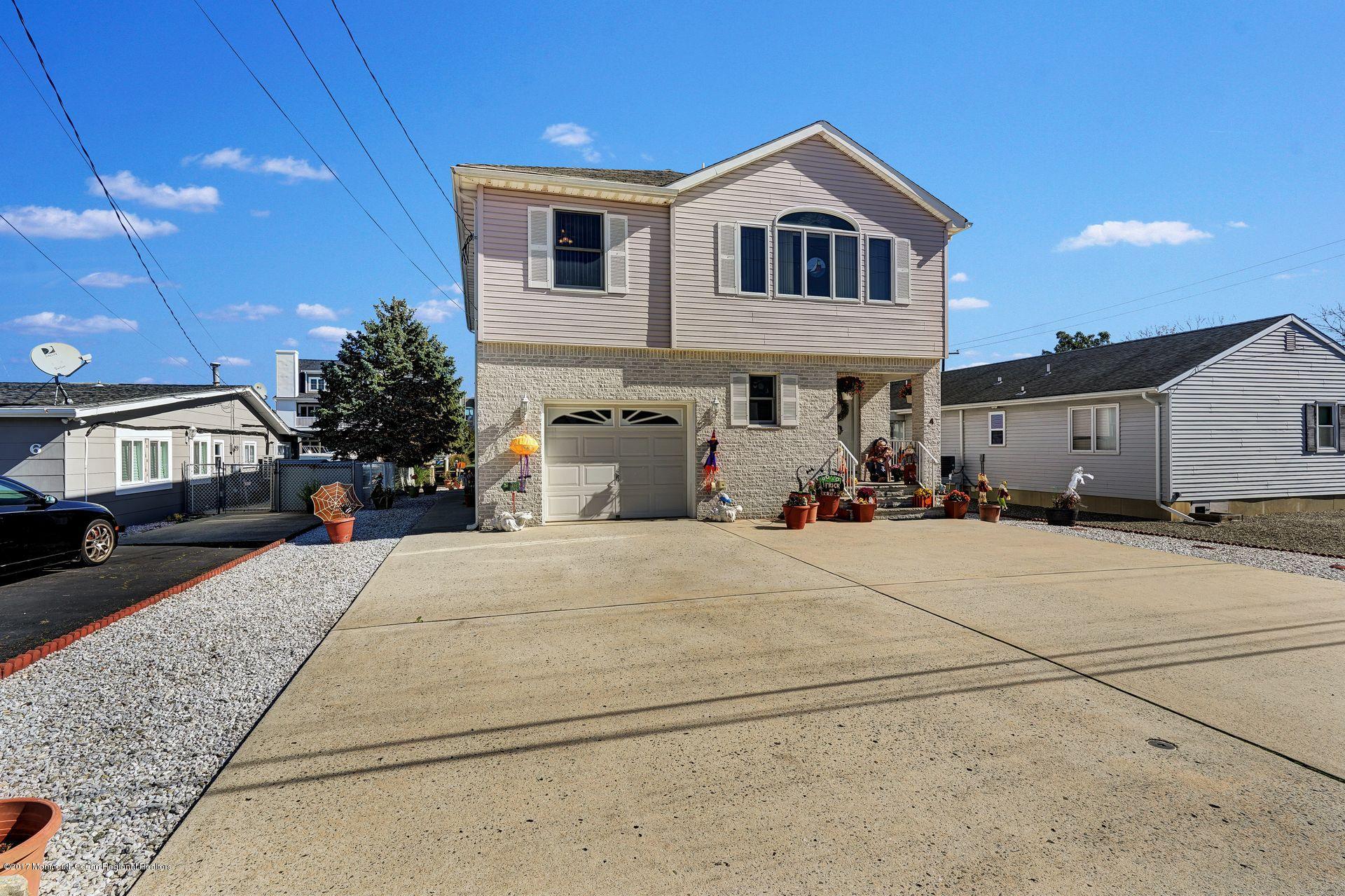 4 Cable Road Waretown, NJ 08758 - Photo 46 of 47 a front view of a house with garage