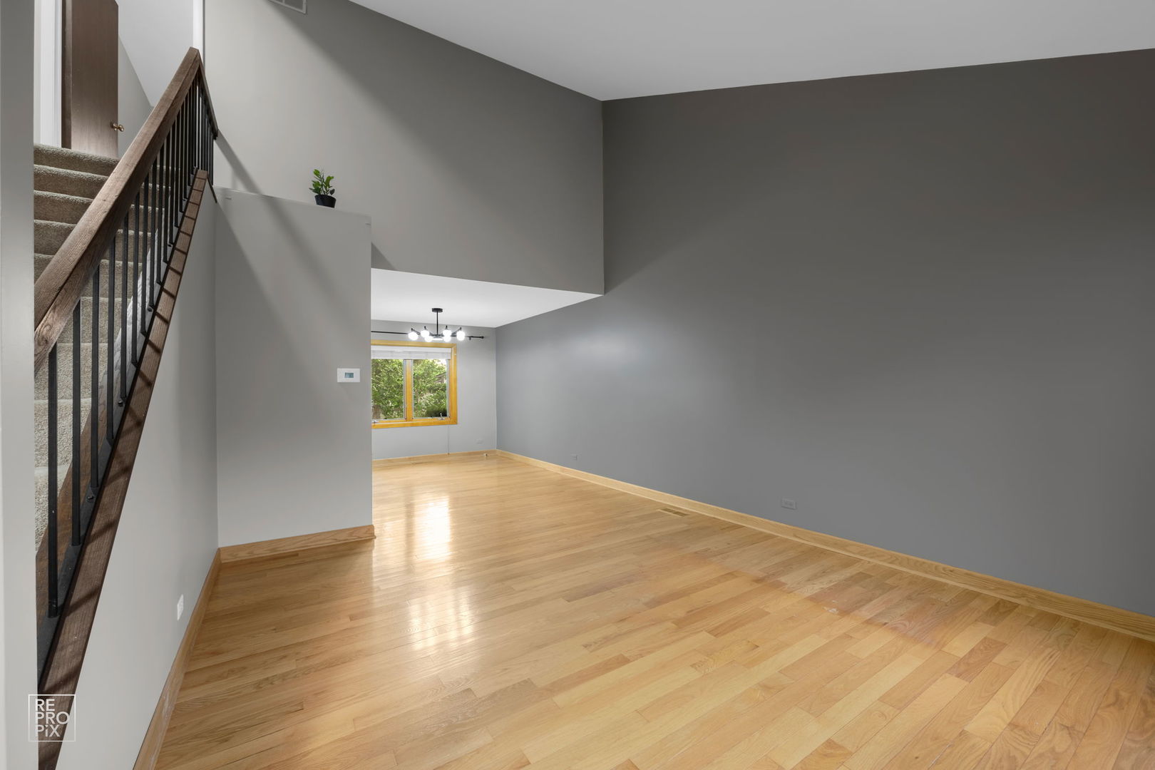 2627 Smith Street Rolling Meadows, IL 60008 - Photo 7 of 23 a view of an empty room with wooden floor and a window