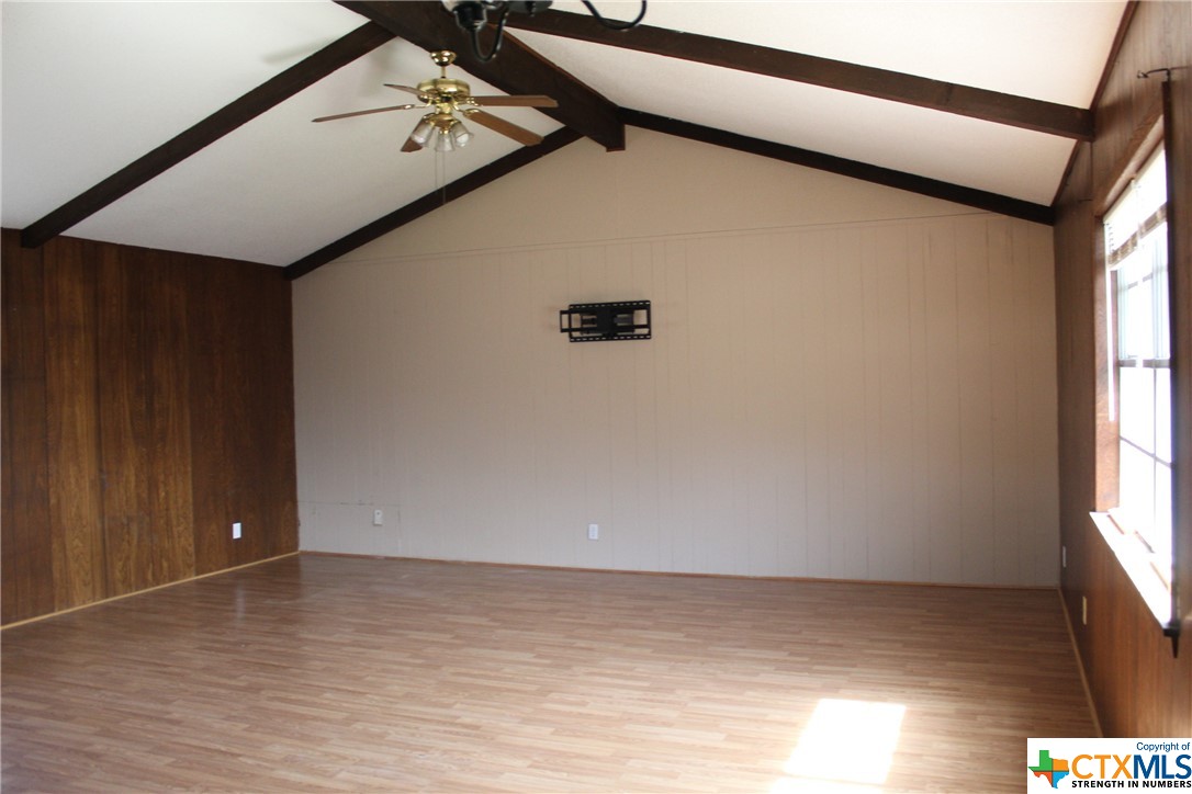 a view of room with window and hardwood floor
