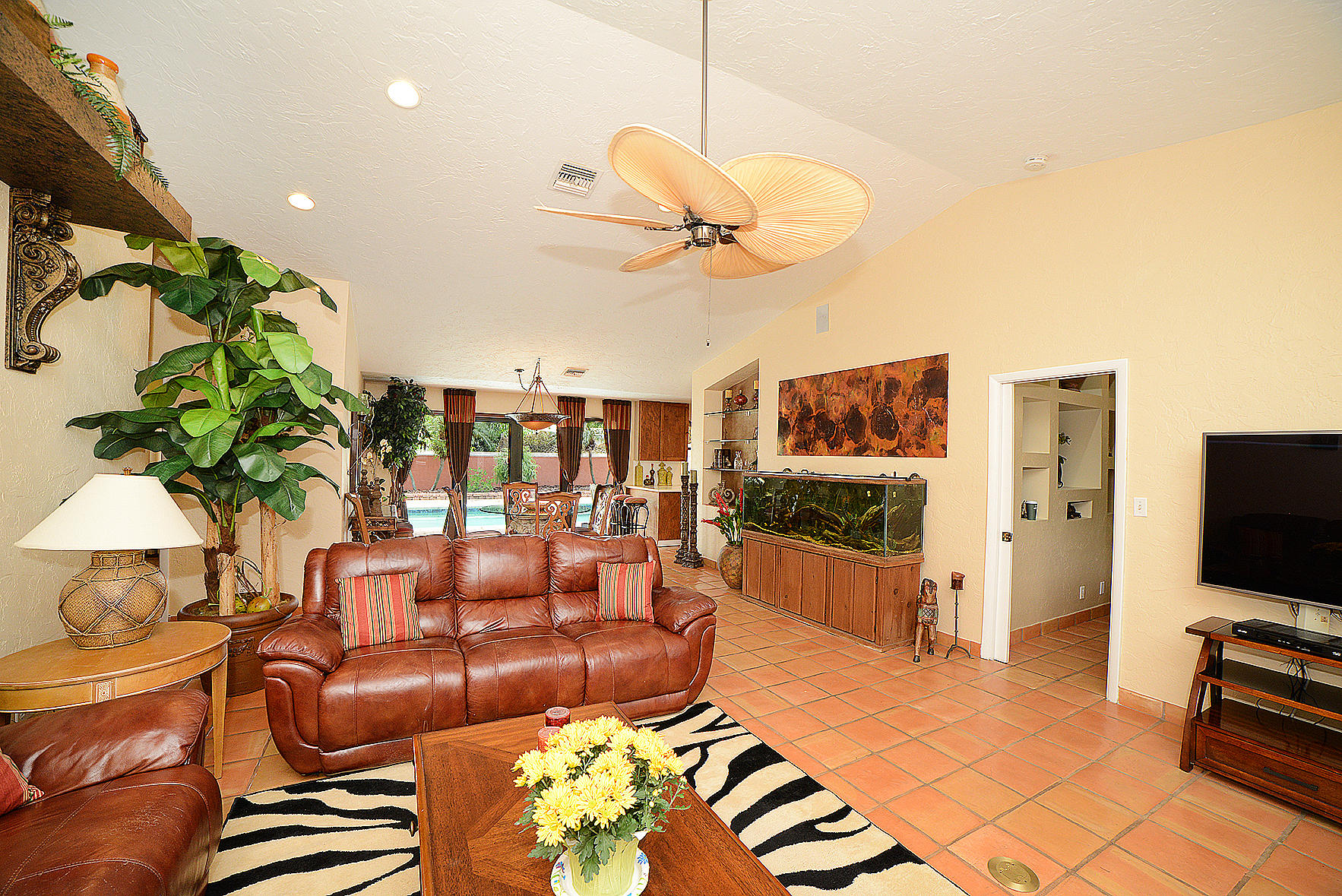647 Northwest 12th Road Boca Raton, FL 33486 - Photo 4 of 27 a living room with furniture a flat screen tv and a dining table