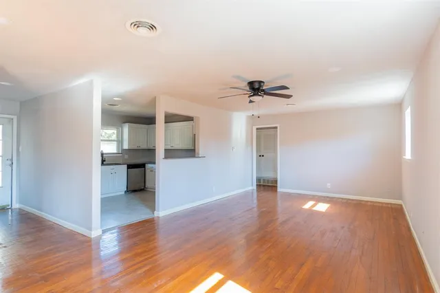 a view of empty room with wooden floor