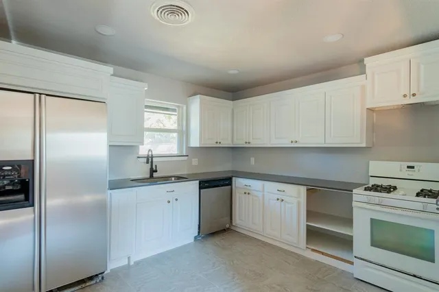 a kitchen with a sink stove and refrigerator