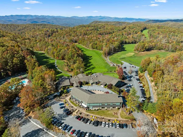 an aerial view of a house with a yard and lake view