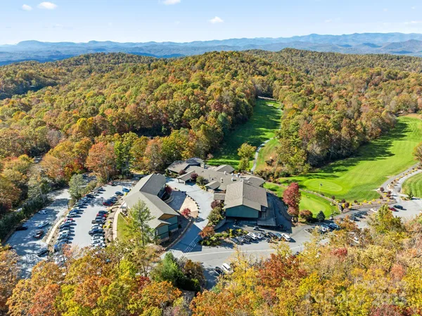 an aerial view of a house with a garden and lake view