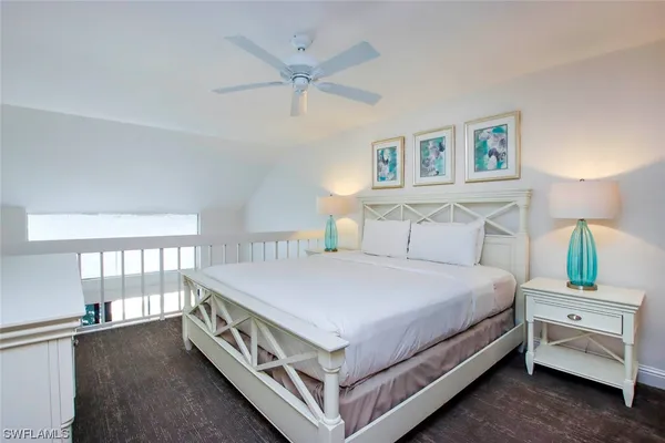 a bedroom with a bed and a flat tv screen on dresser
