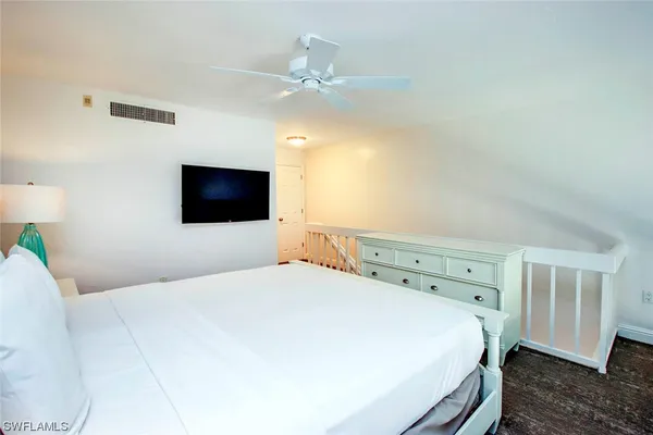 a bedroom with a bed and a tv