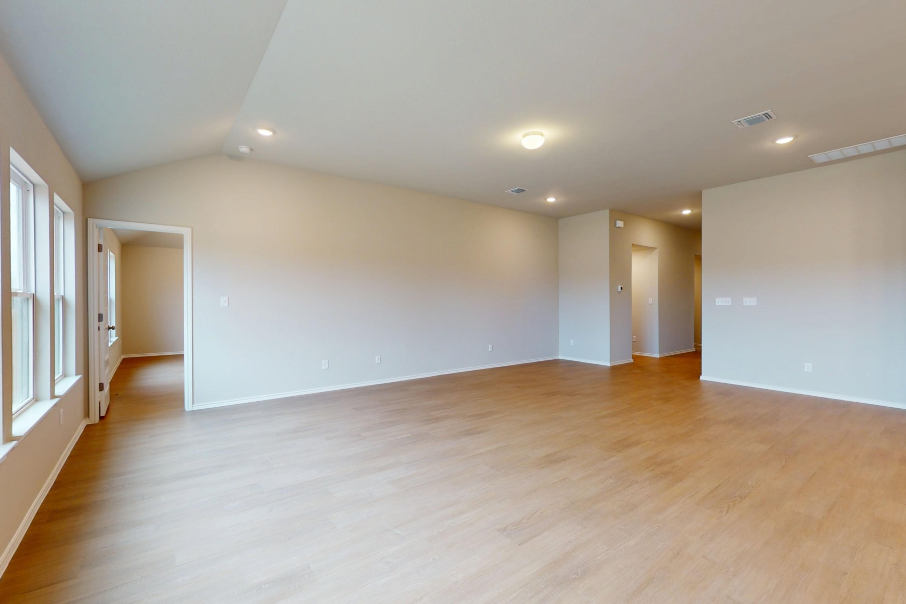 19917 Schatz Way Manor, TX 78653 - Photo 12 of 33 an empty room with wooden floor and windows