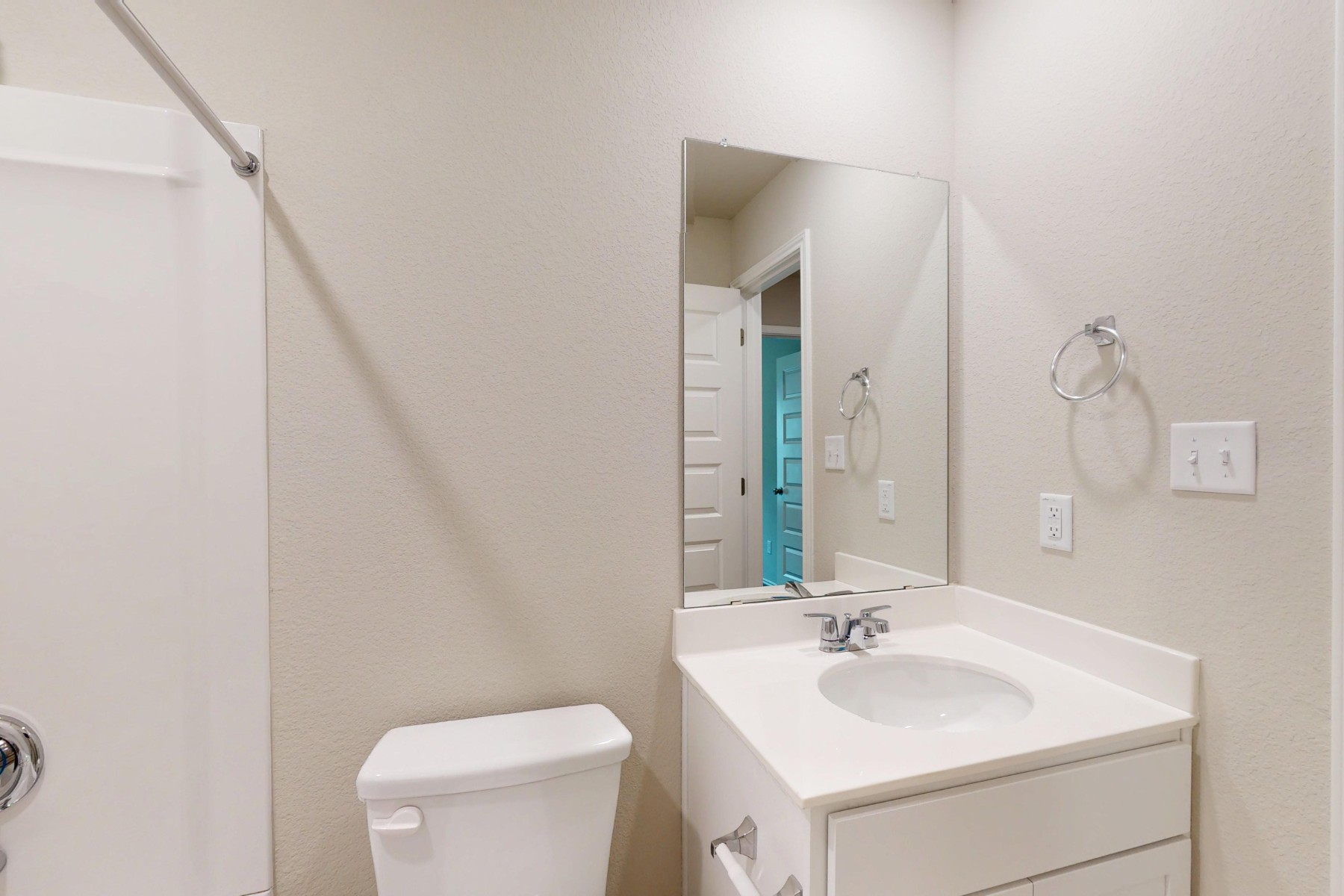 19917 Schatz Way Manor, TX 78653 - Photo 27 of 33 a bathroom with a toilet a sink and a mirror