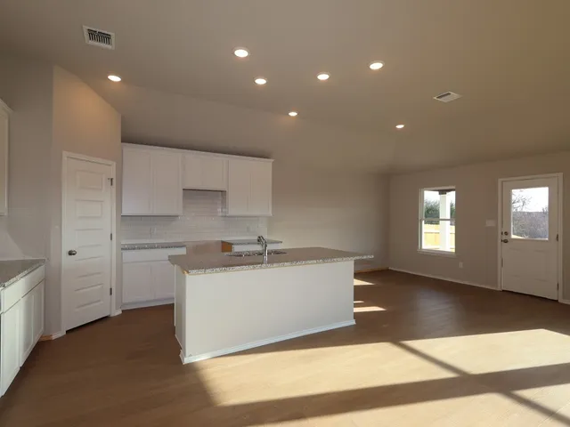 a kitchen with sink and cabinets
