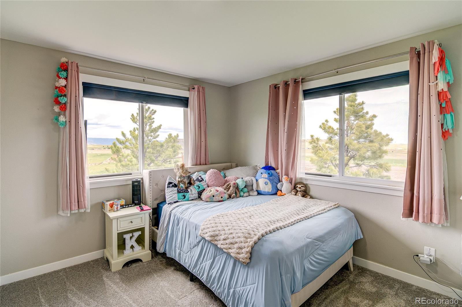 4531 East Best Road Larkspur, CO 80118 - Photo 21 of 49 a bedroom with a bed and a window