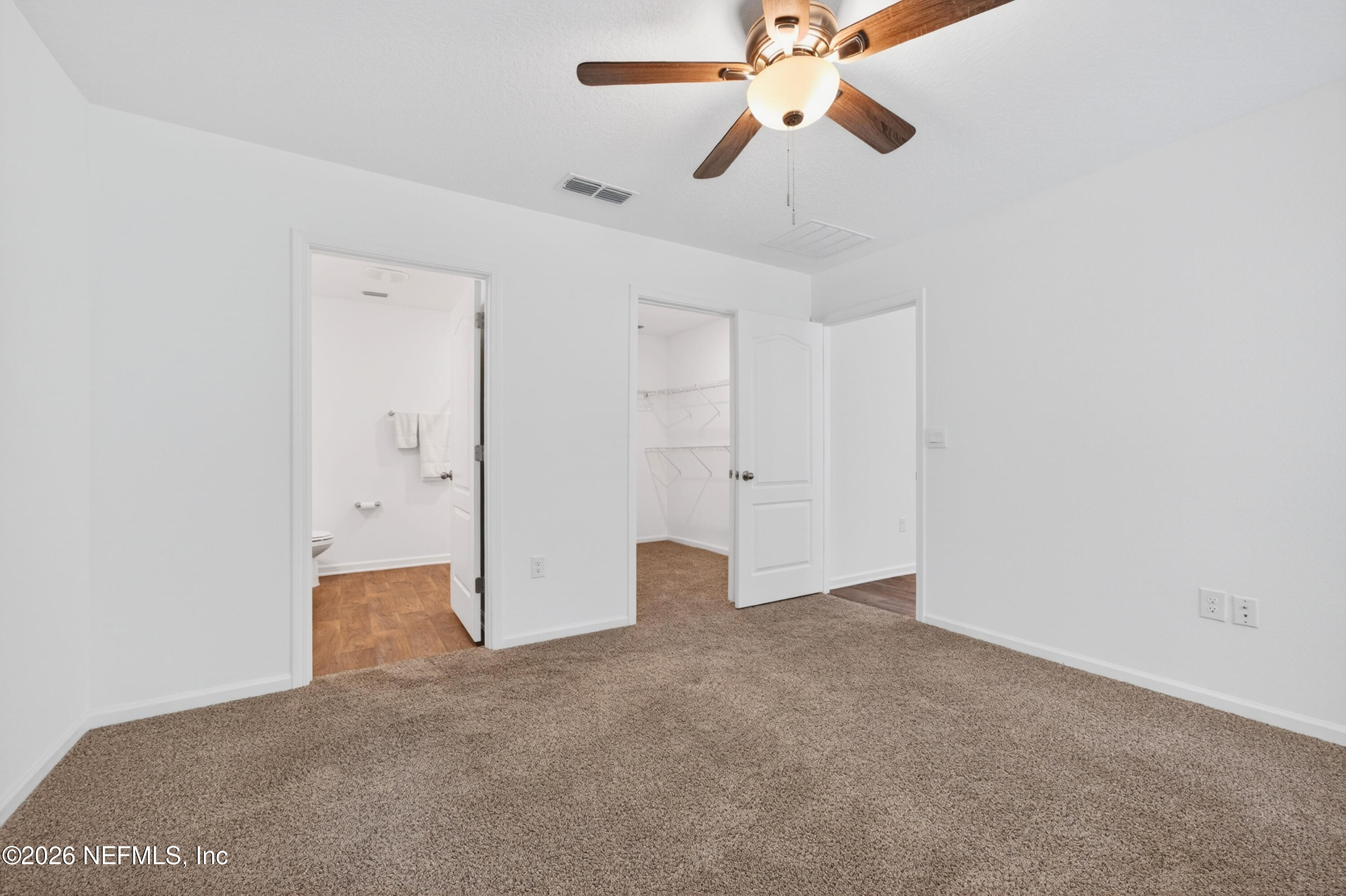 231 Encanto Way Street St. Augustine, FL 32084 - Photo 15 of 36 an empty room with closet and a chandelier fan
