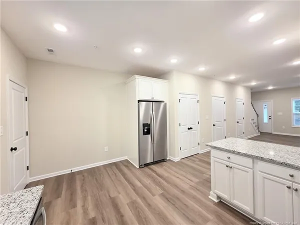 a view of a kitchen cabinets a sink and dishwasher with wooden floor