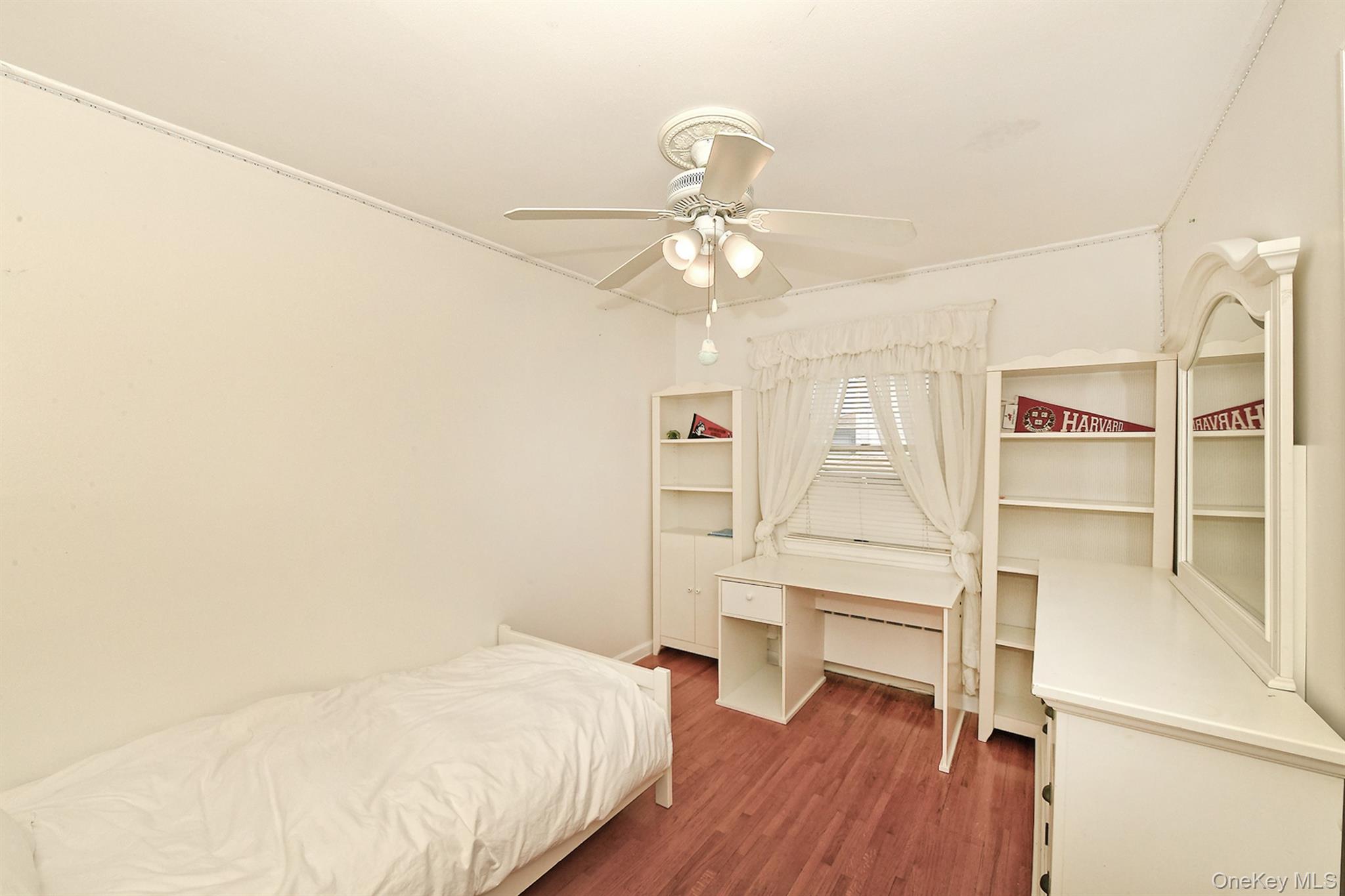 53 Stuart Drive Syosset, NY 11791 - Photo 12 of 24 a bedroom with a bed and a chandelier