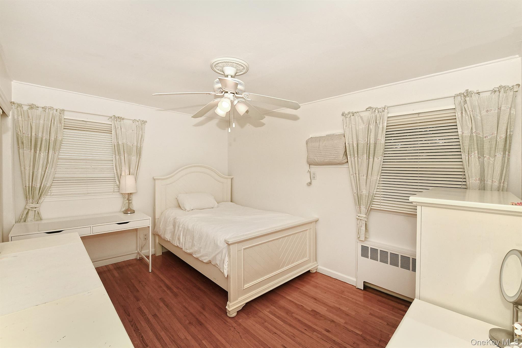 53 Stuart Drive Syosset, NY 11791 - Photo 13 of 24 a white bed sitting in a room next to a window