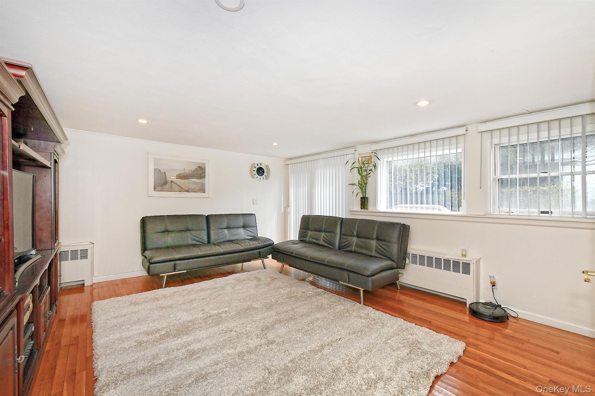 53 Stuart Drive Syosset, NY 11791 - Photo 15 of 24 a living room with furniture and a flat screen tv