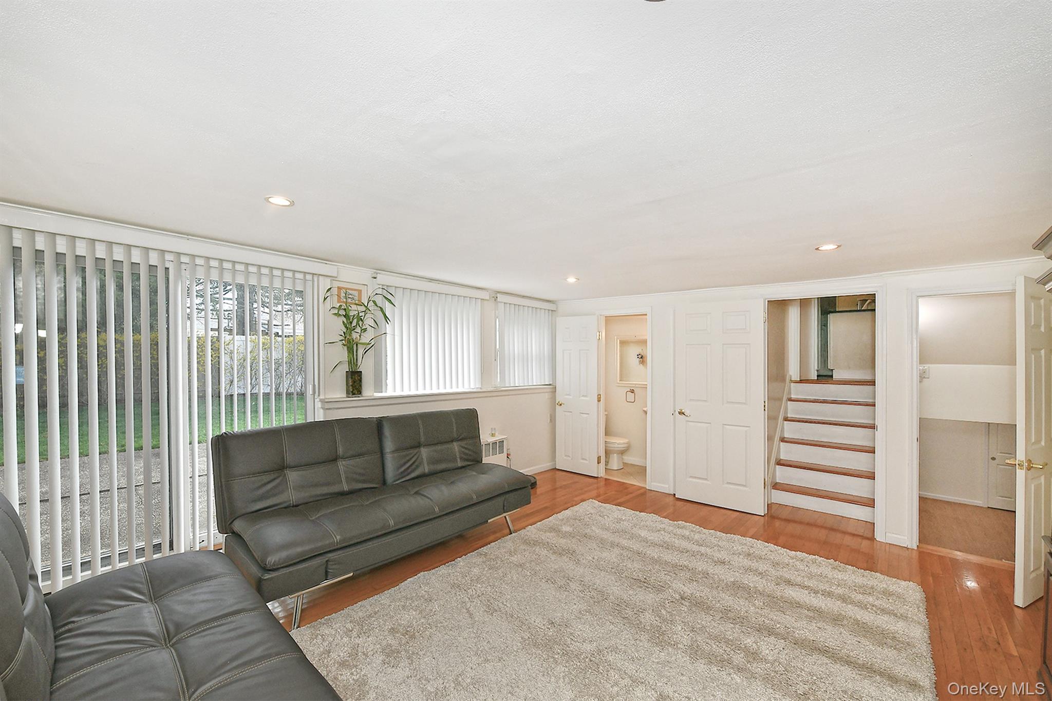 53 Stuart Drive Syosset, NY 11791 - Photo 16 of 24 a living room with furniture and a gate