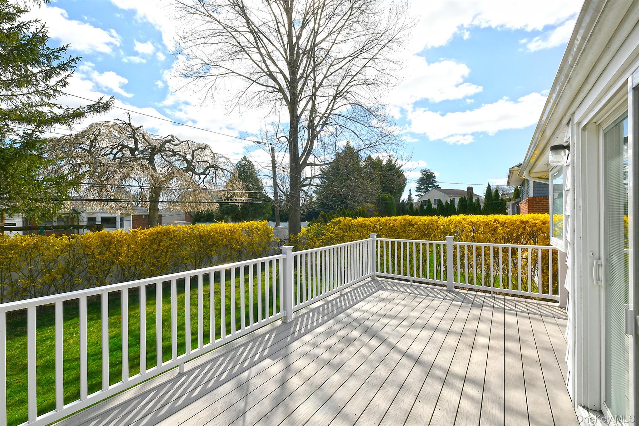 53 Stuart Drive Syosset, NY 11791 - Photo 20 of 24 a view of balcony with wooden floor and fence