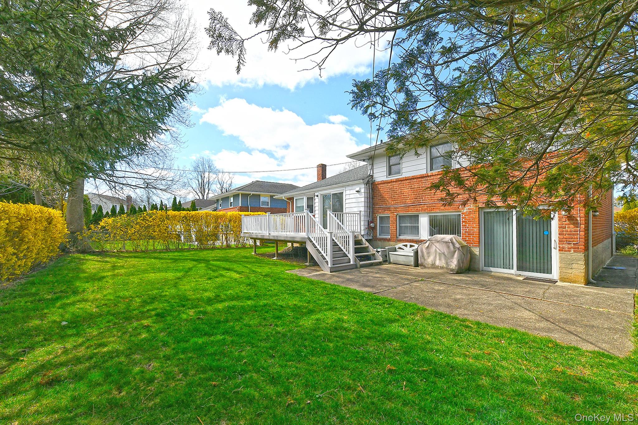 53 Stuart Drive Syosset, NY 11791 - Photo 22 of 24 a view of a house with a yard porch and sitting area