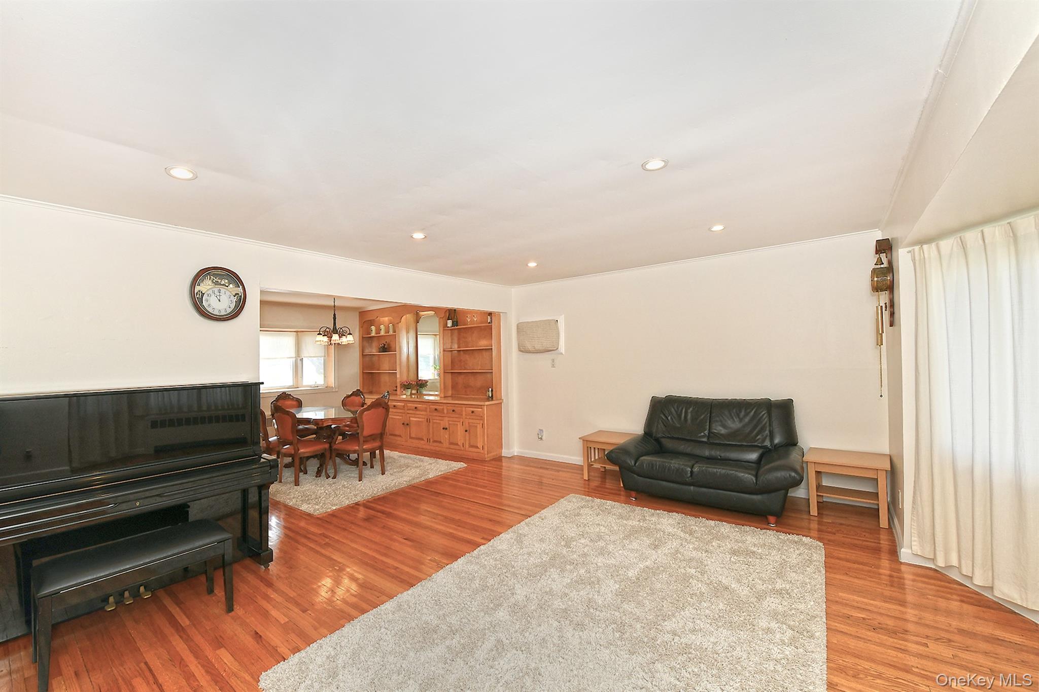 53 Stuart Drive Syosset, NY 11791 - Photo 4 of 24 a living room with furniture and wooden floor