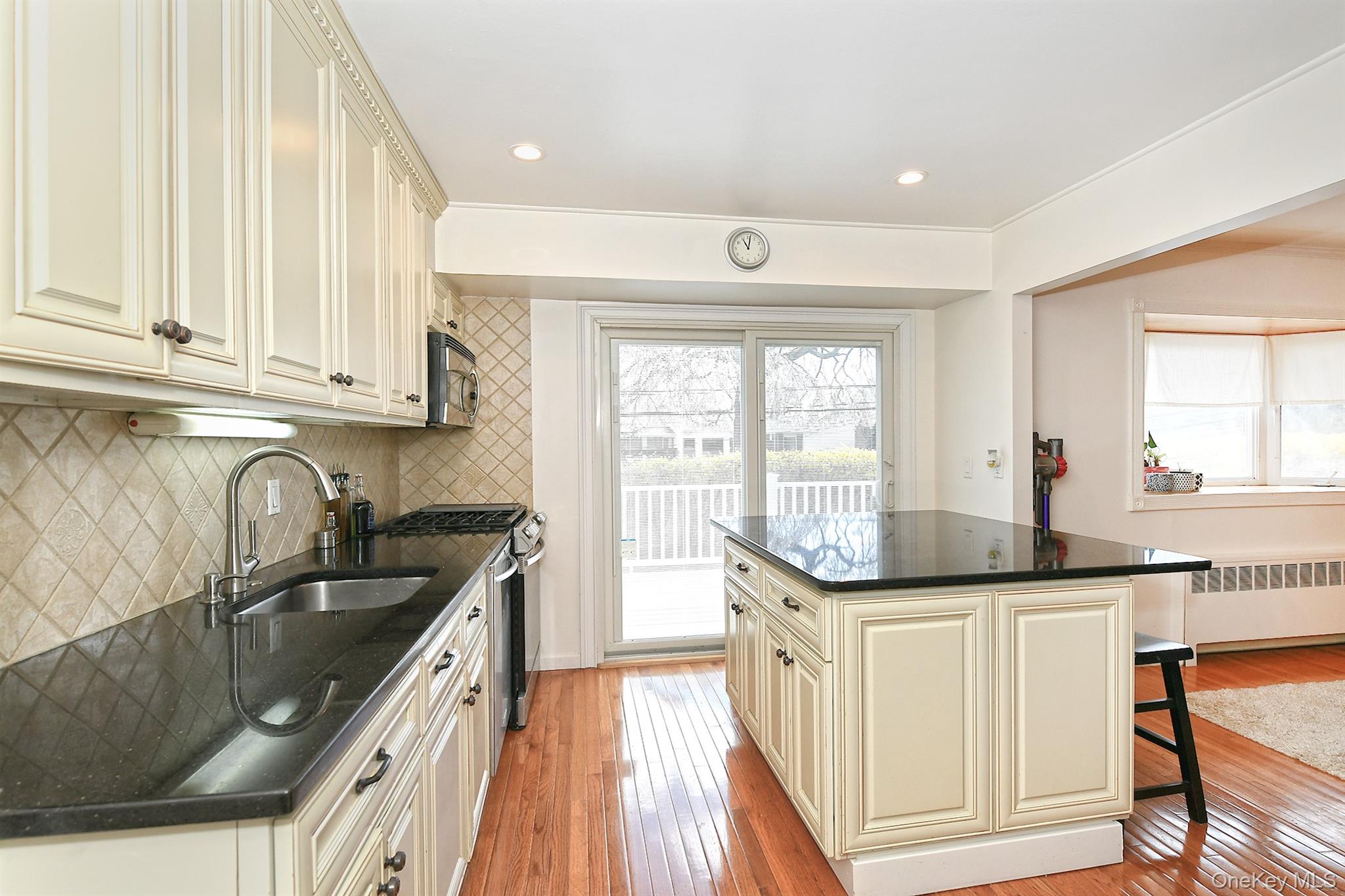 53 Stuart Drive Syosset, NY 11791 - Photo 7 of 24 a kitchen with granite countertop a sink and cabinets