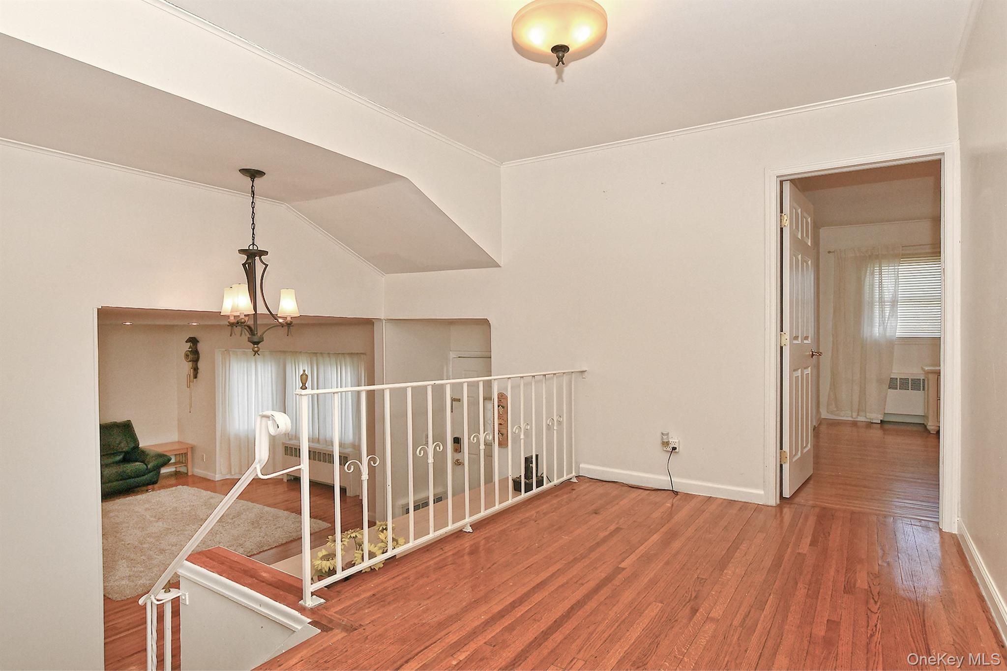 53 Stuart Drive Syosset, NY 11791 - Photo 10 of 24 a view of a livingroom with wooden floor and staircase