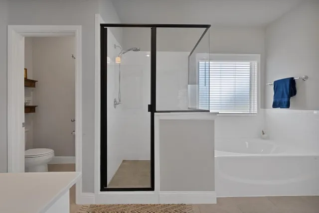 a bathroom with a bathtub and a shower