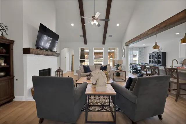 a living room with fireplace furniture and a flat screen tv