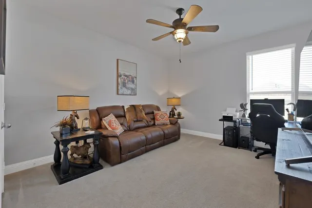 a living room with furniture a window and a flat screen tv