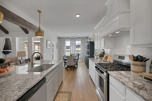a kitchen with counter top space a sink and appliances
