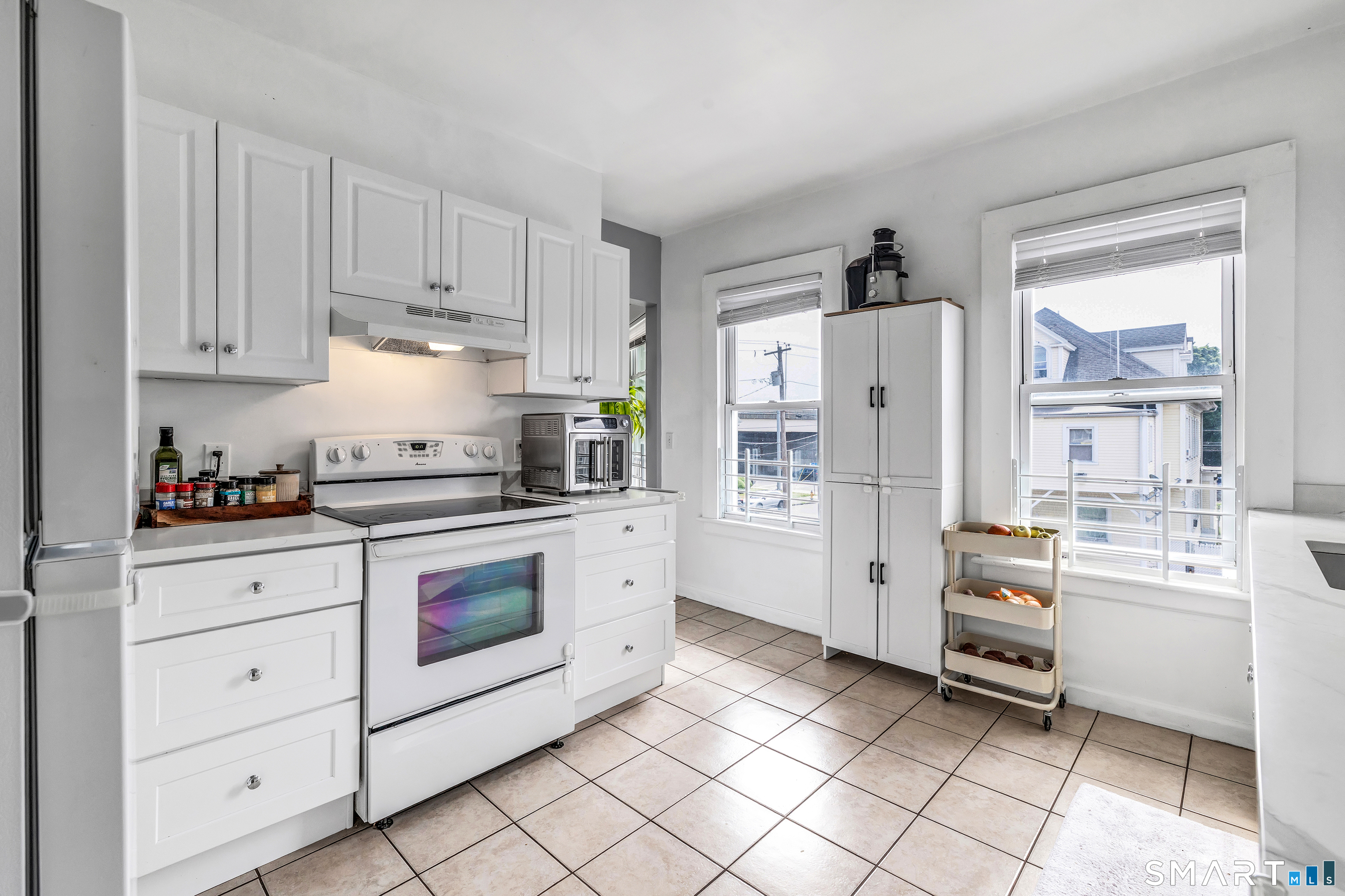 189 Wells Street Bridgeport, CT 06606 - Photo 12 of 40 2nd Floor Offers 1389 sq ft -new kitchen - quartz countertops, abundance of white cabinets, electric stove, fridge, dishwasher, washer/dryer