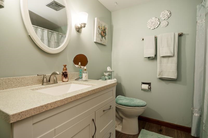 17427 West Douglas Road Brodhead, WI 53520 - Photo 87 of 89 a bathroom with a toilet a sink and mirror