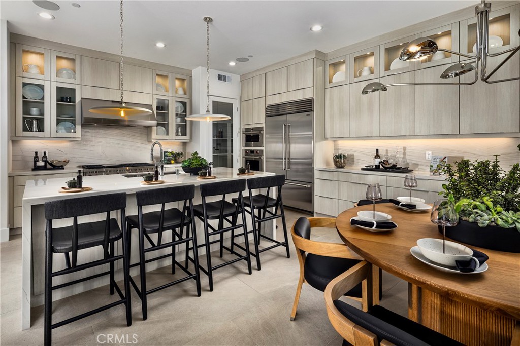 109 Apron Irvine, CA 92618 - Photo 1 of 16 a kitchen with stainless steel appliances kitchen island granite countertop a table chairs stove and cabinets