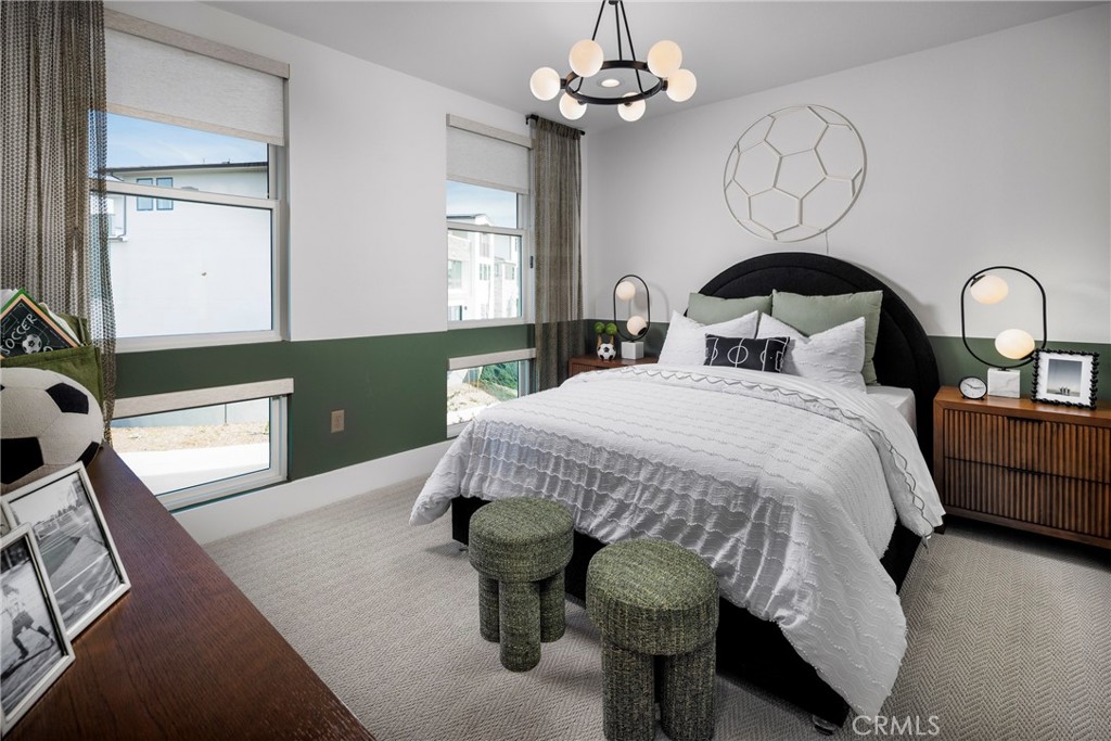 109 Apron Irvine, CA 92618 - Photo 11 of 16 a bed sitting in a bedroom next to a window with chandelier