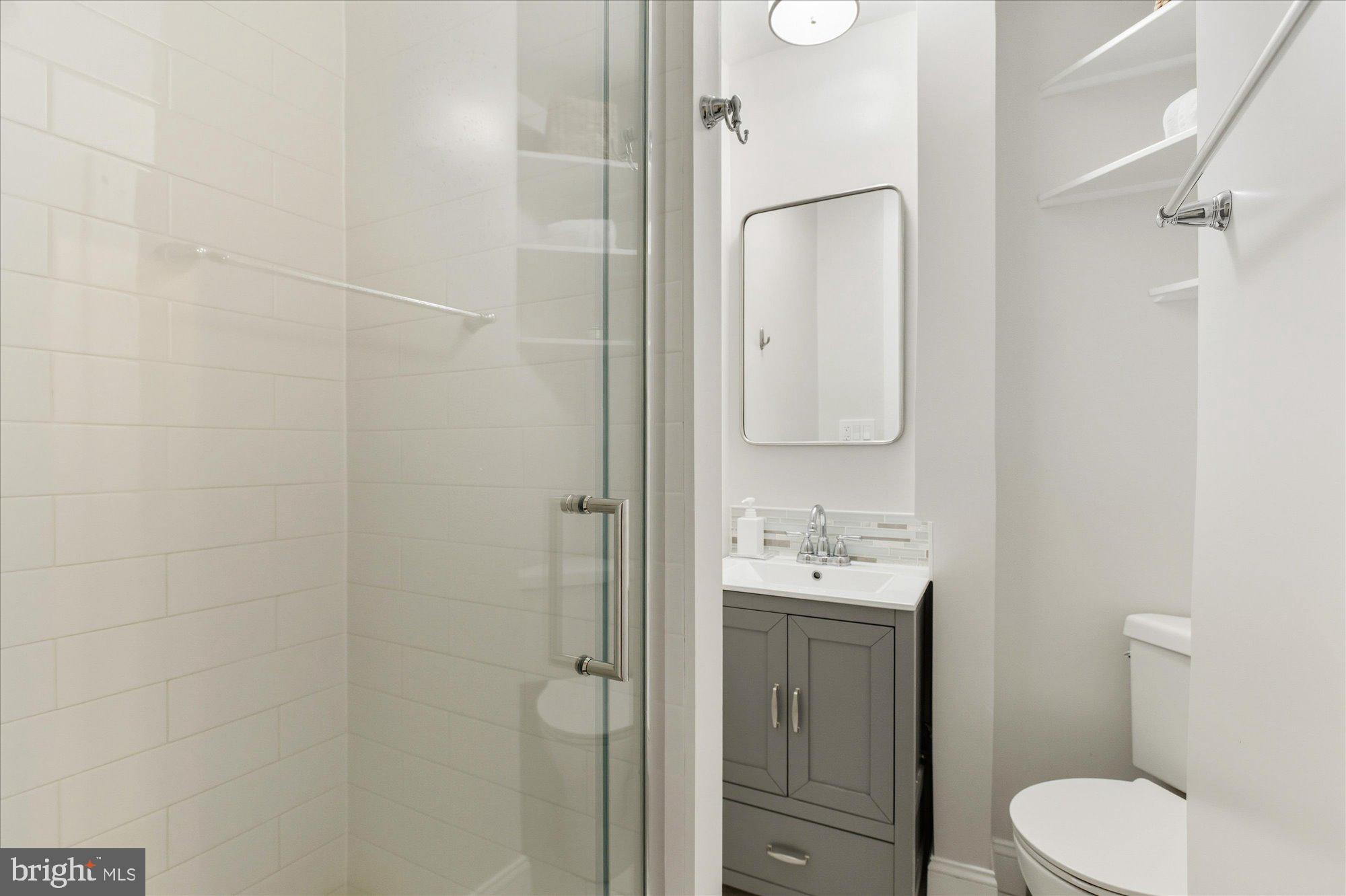 1341 28th Street Northwest Washington, DC 20007 - Photo 13 of 17 a bathroom with a toilet sink vanity and shower