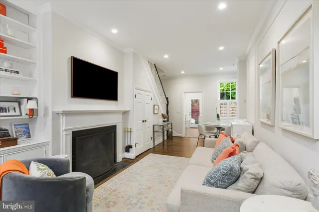 a living room with furniture a fireplace and a flat screen tv