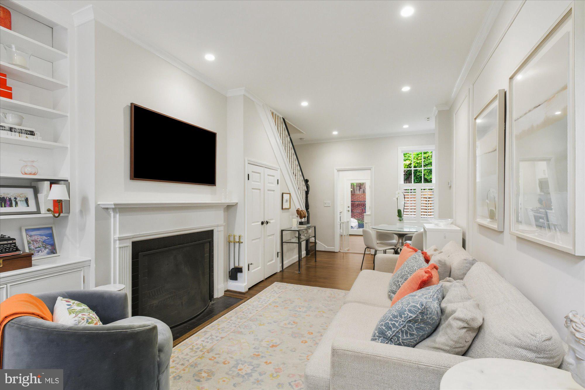1341 28th Street Northwest Washington, DC 20007 - Photo 2 of 17 a living room with furniture a fireplace and a flat screen tv