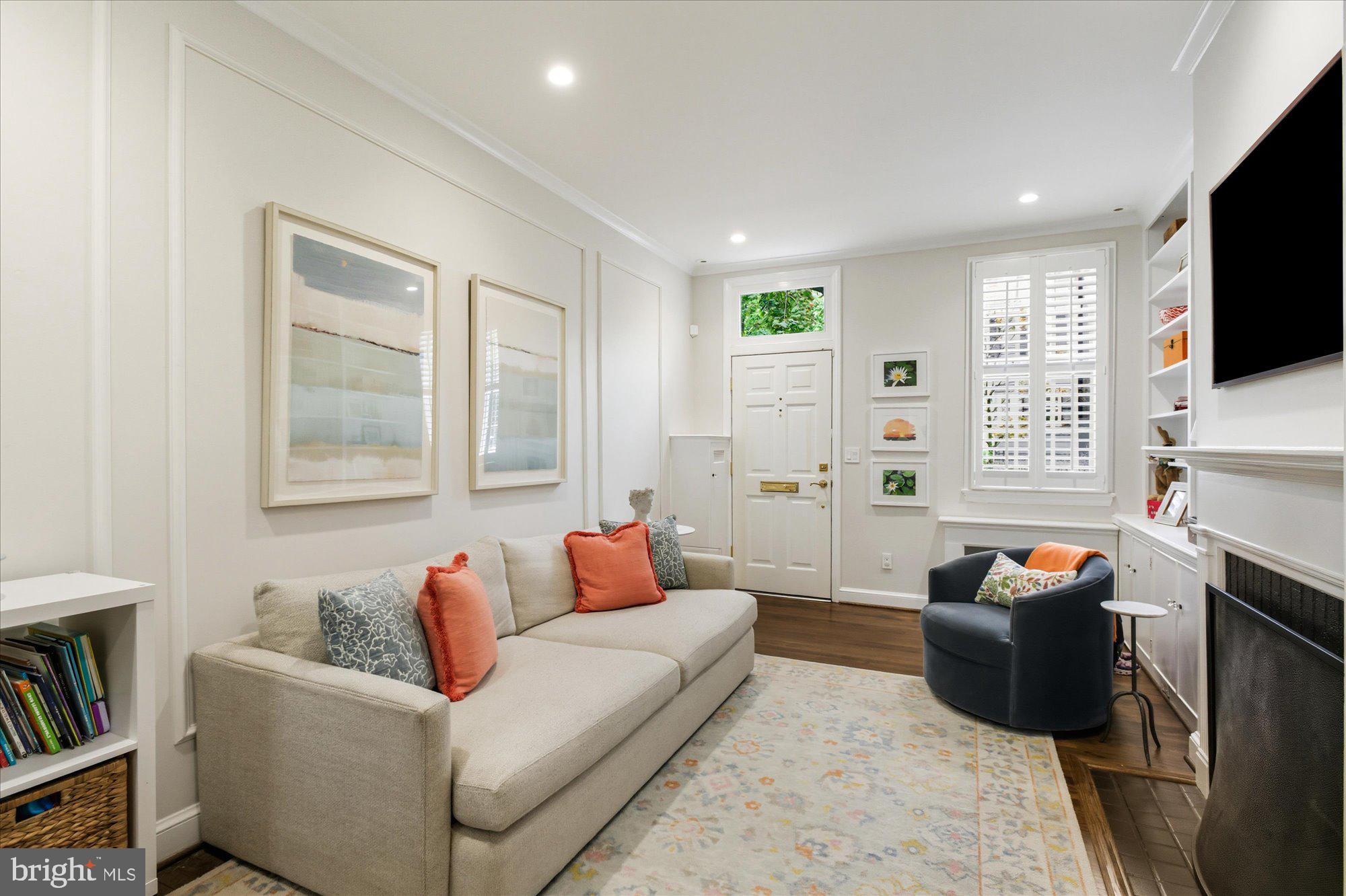 1341 28th Street Northwest Washington, DC 20007 - Photo 4 of 17 a living room with fireplace furniture and a flat screen tv
