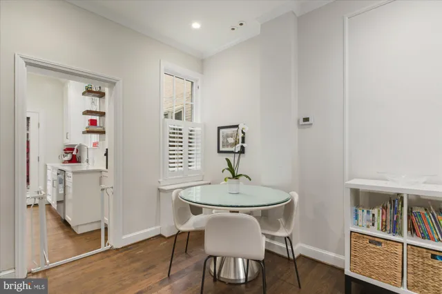 a dining room with furniture and wooden floor