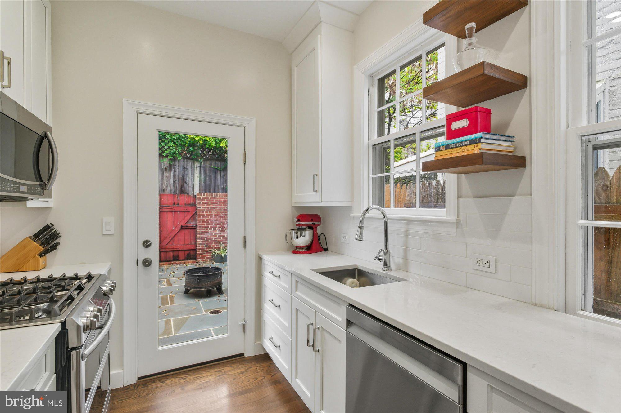 1341 28th Street Northwest Washington, DC 20007 - Photo 7 of 17 a kitchen with stainless steel appliances granite countertop a stove and a sink