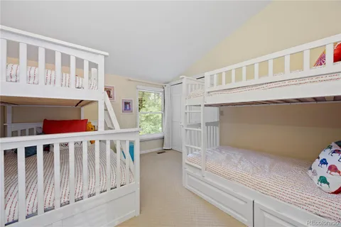 a living room with furniture and a book shelf