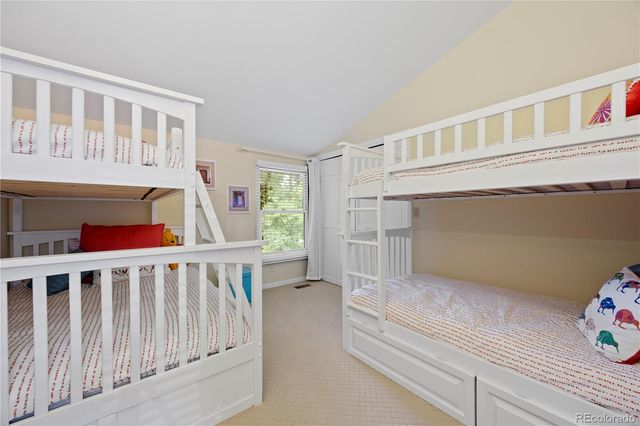 a living room with furniture and a book shelf